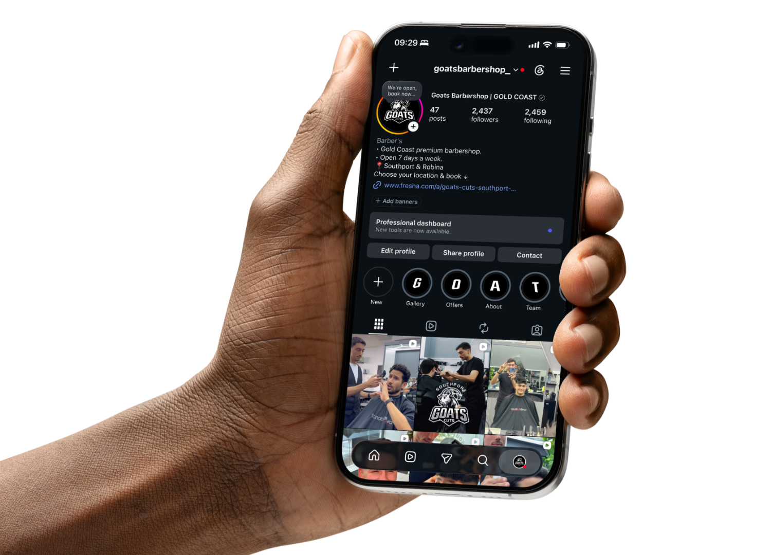 A hand holding a mobile phone showing the GOATS Barbershop Instagram profile
